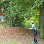 Disc golfer practice putting uphill to increase his putting distance