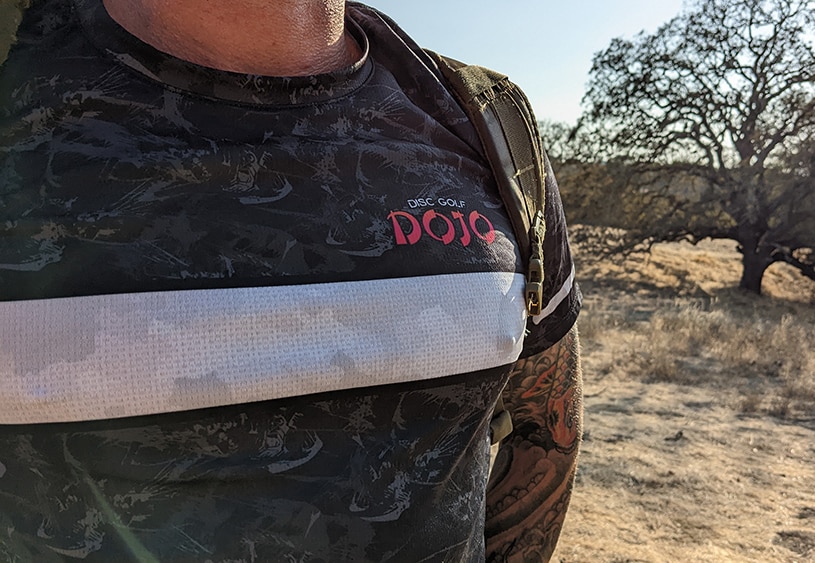 disc golf jersey with Dojo logo shot on the course
